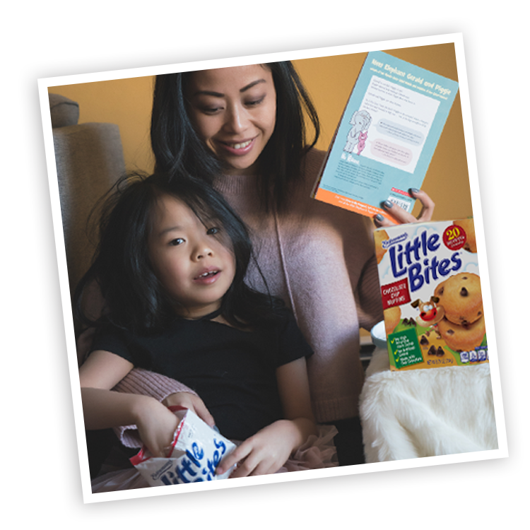 Mother and child with Little Bites Chocolate Chip muffins package