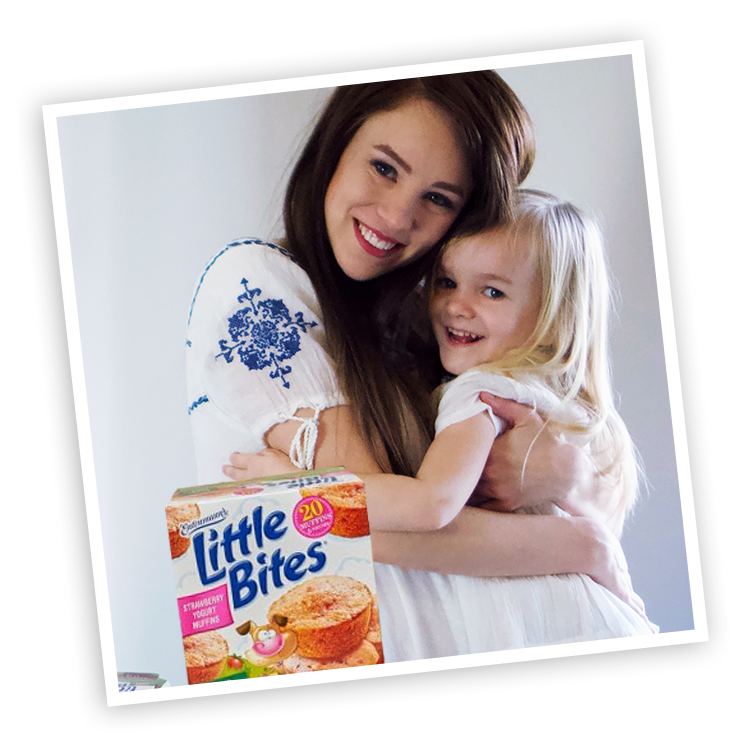 Mother and child with Little Bites Strawberry Yogurt muffins package