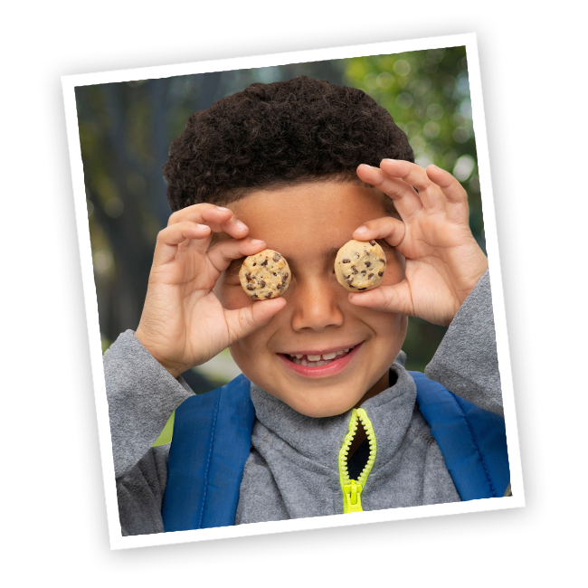 child with cinnamuffin cookies