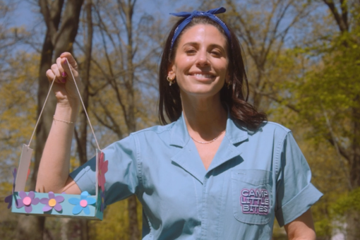 Woman holding homemade bird feeder.